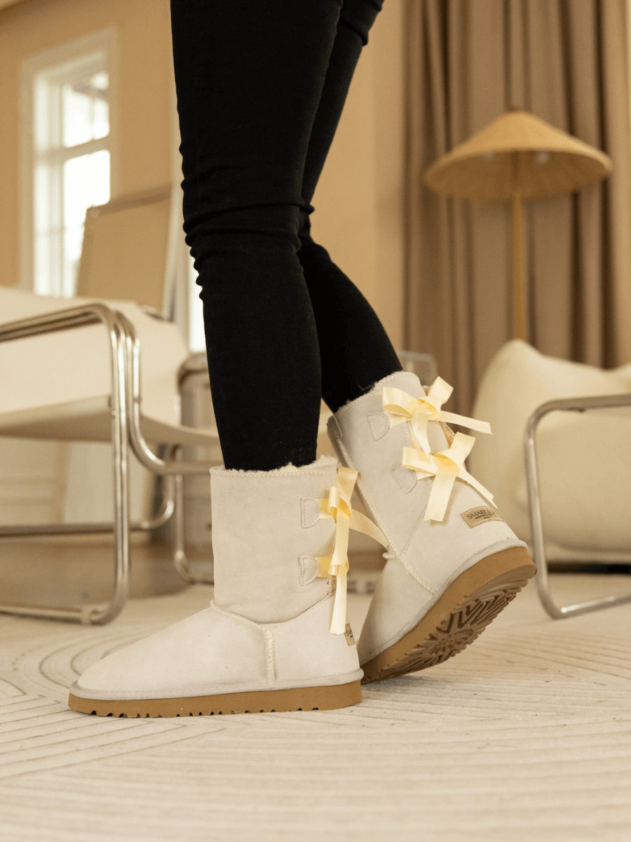 Smaibulun Ugg | Double Ballet Ribbon Bow Suede Shearling Boots - Ivory